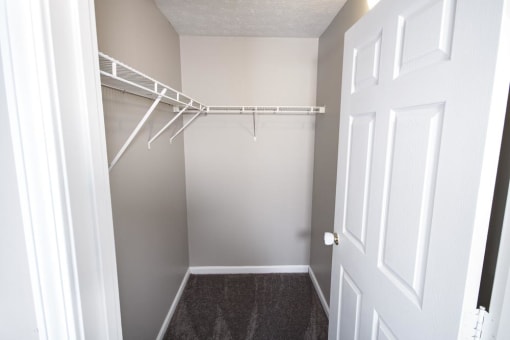 Large closet with white walls and a shelf at Conner Court apartments in Connersville, IN