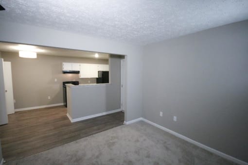 Empty living room with a kitchen in the background a tCanterbury House apartments in Tipton, Indiana