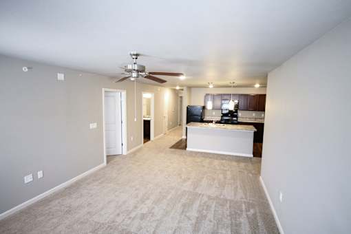 A living room with a television and a ceiling fan.