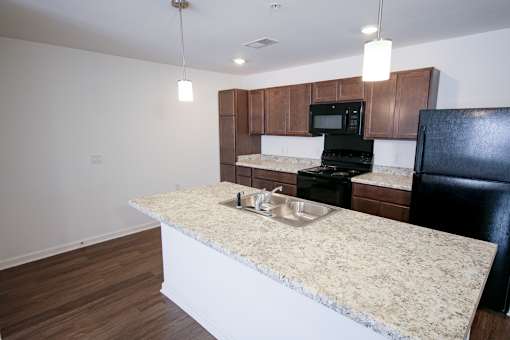 A kitchen with sink, fridge, and stove indmiller Pointe apartments in Columbus, Ohio