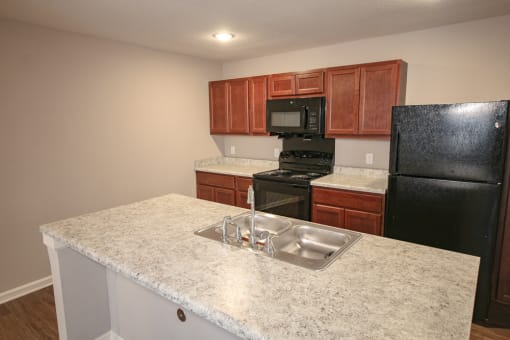 Kitchen with sink and stove at Meadows on Main in Whitestown, Indiana