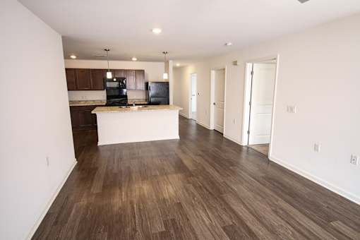 An empty living room with wood floor at Windmiller Pointe apartments in Columbus, Ohio