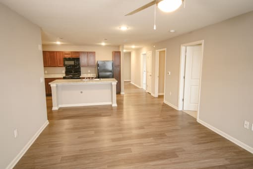 Apartment living room with wood floor at Meadows on Main in Whitestown, Indiana
