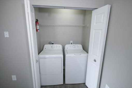White washer and dryer in a room at Canterbury House apartments in Logansport, Indiana