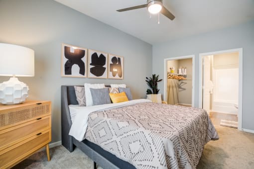 a bedroom with a bed and a ceiling fan