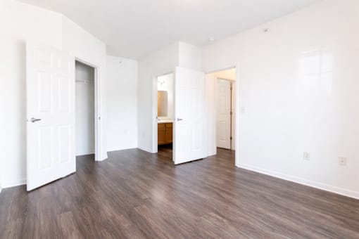 A room with white walls and wooden floors.