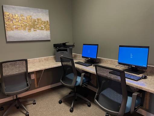 A room with two computers and two chairs.