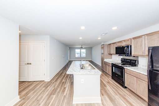 A kitchen with a white island in the middle of the room.