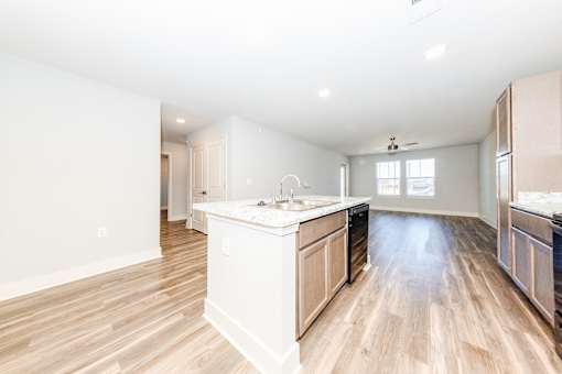 A kitchen with wooden floors and white walls.
