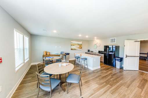 A kitchen with a table and chairs in the middle of the room.