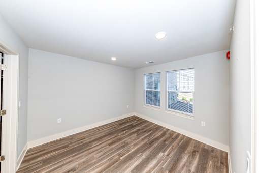 A room with wooden flooring and a window.
