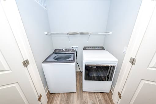 A small laundry room with a washer and dryer.