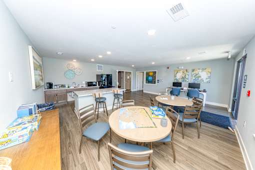 A kitchen with a table and chairs in the middle of the room.
