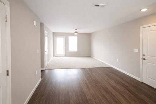 A room with wooden floors and white walls.