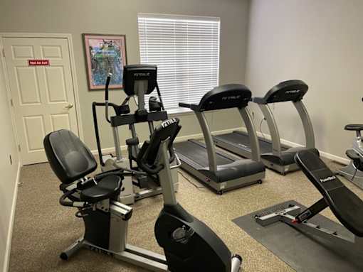 A gym with treadmills and elliptical machines.