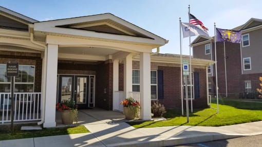 Clubhouse exterior with a flag in front of it at Mosaic Apartments in Avon, Indiana