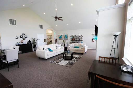 Clubhouse living room with couches and a coffee table at Canterbury Apartments in Kalamazoo, Mi