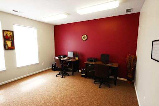 two desks with computers and chairs at canterbury apartments in kalamazoo, mi
