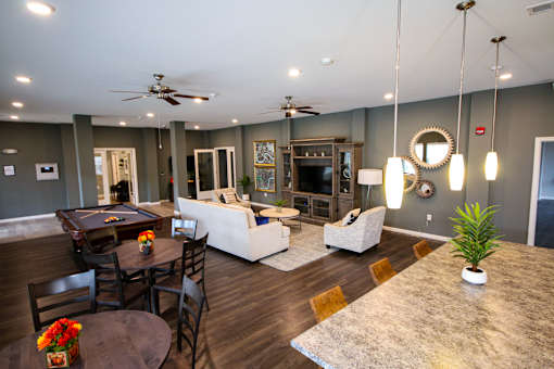 A living room with a dark wood floor and furniture.