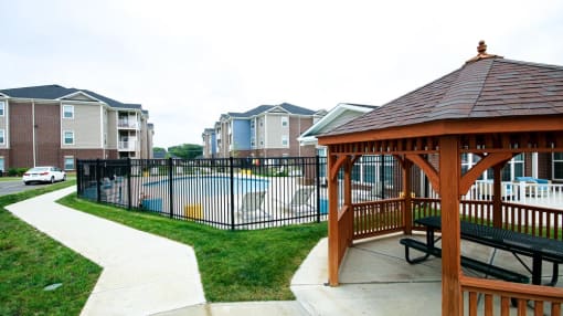 Gazebo in front of a pool with apartment buildings in the background at Mosaic Apartments in Avon, Indiana