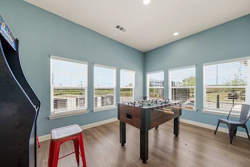 A room with a pool table and a chair.