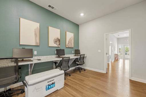 A room with a white fridge and a table with chairs.