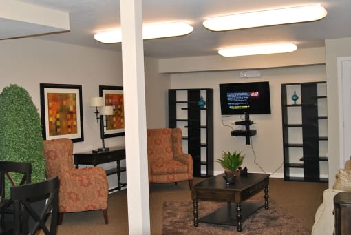 a lounging area with chairs and a coffee table