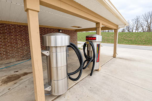 A gas station with a red and white sign that says "McGUIR".