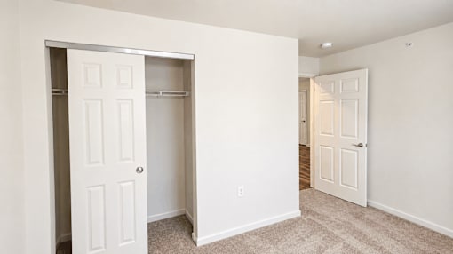 A white door is open to a hallway.