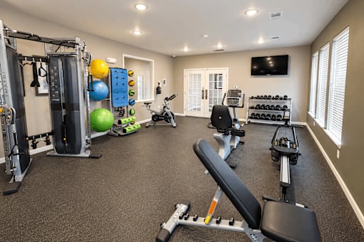 A well-equipped home gym with a variety of exercise equipment.