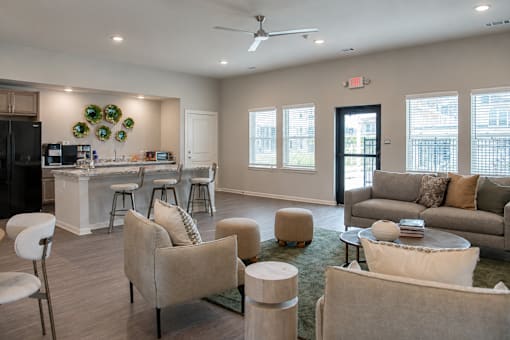 A spacious living room with a kitchen area in the background.