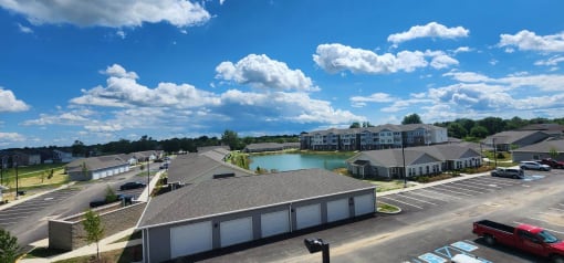 an aerial view of a community with a lake and buildings