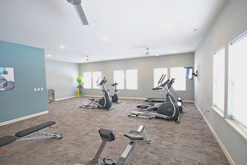 A spacious gym with a variety of exercise equipment.