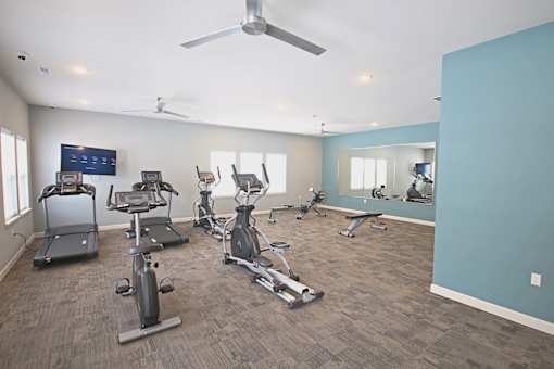 A spacious gym with a variety of exercise equipment.