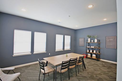 A conference room with a long table and chairs.