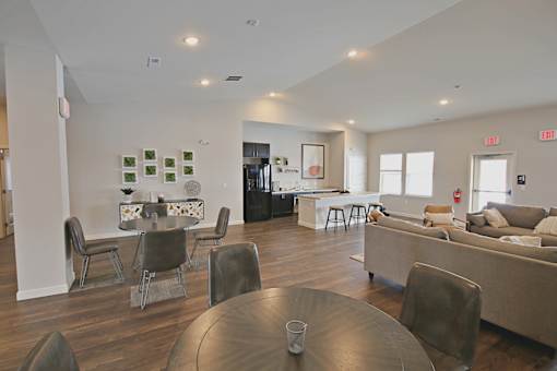 A modern living room with a dining table and chairs.