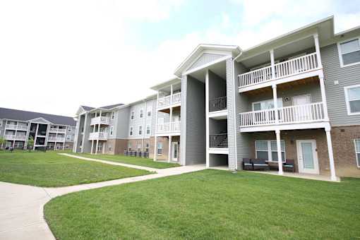 Apartment complex with a green lawn in front.