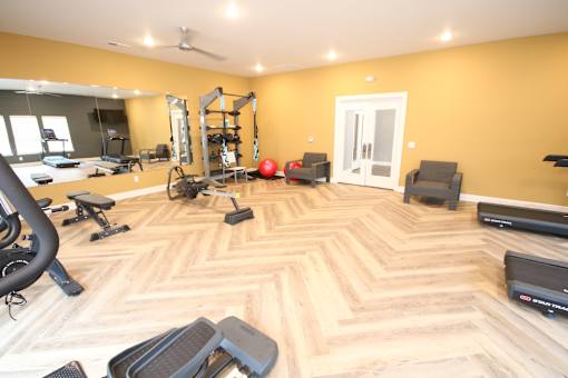 A spacious home gym with a variety of exercise equipment.