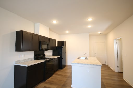 a kitchen with black appliances and granite counter tops and