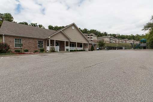 A house with a grey roof and a driveway in front.