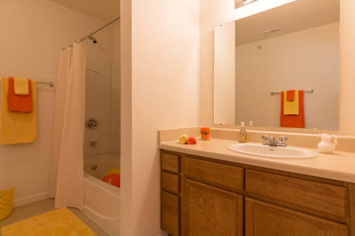A bathroom with a white sink and a white bathtub.