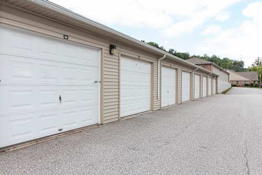A long row of white garage doors are closed.