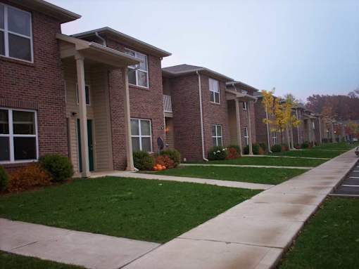 Apartment building with a walkway in front.