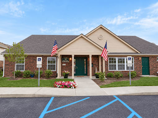 A building with two American flags on either side of the entrance.