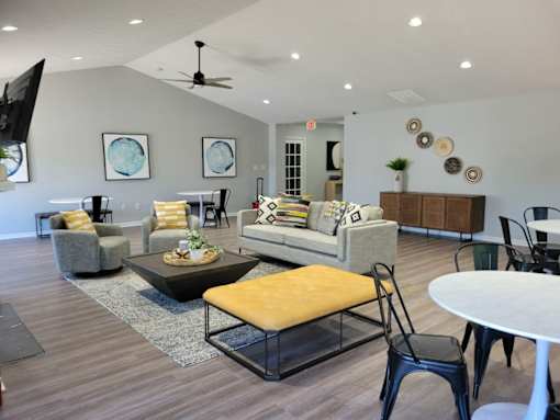 A living room with a couch, chairs, and a coffee table.