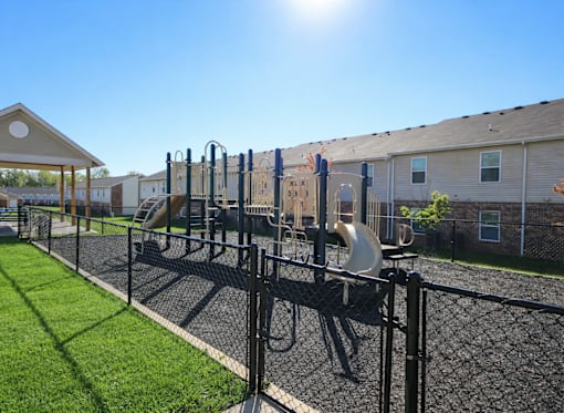 A playground with a slide and a climbing frame.