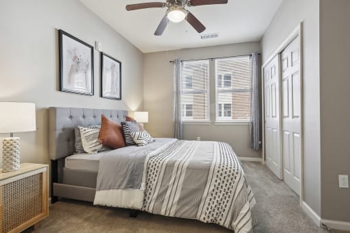 a bedroom with a bed and a ceiling fan
