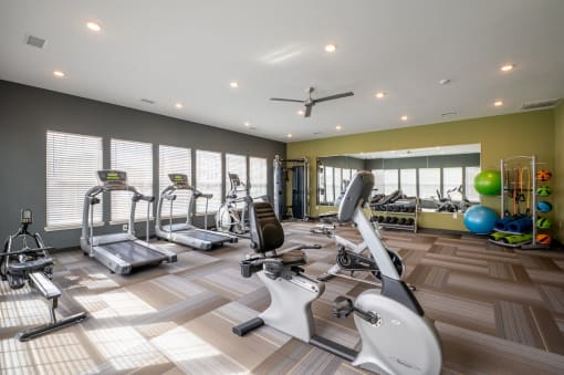 Fitness center with treadmills and other exercise equipment at Mosaic Apartments in Avon, Indiana