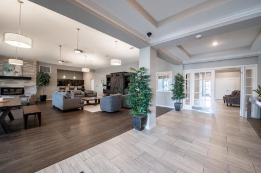 Clubhouse with with a plant and couches in the background at Mosaic Apartments in Avon, Indiana