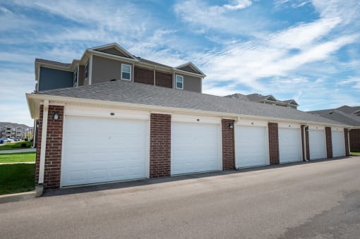 A row of garages with white doors at Mosaic Apartments in Avon, Indiana